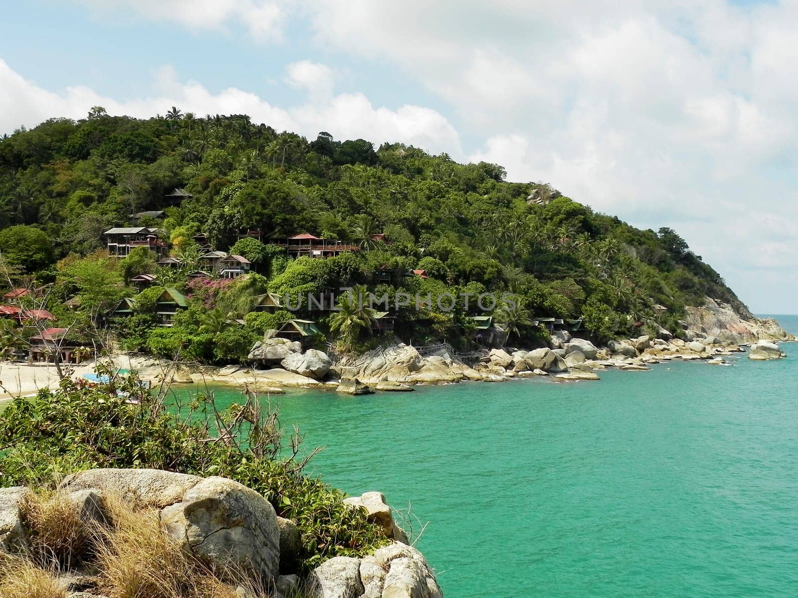 Beautiful coast with azure water cliffs and green jungle on Koh Phangan. Thailand