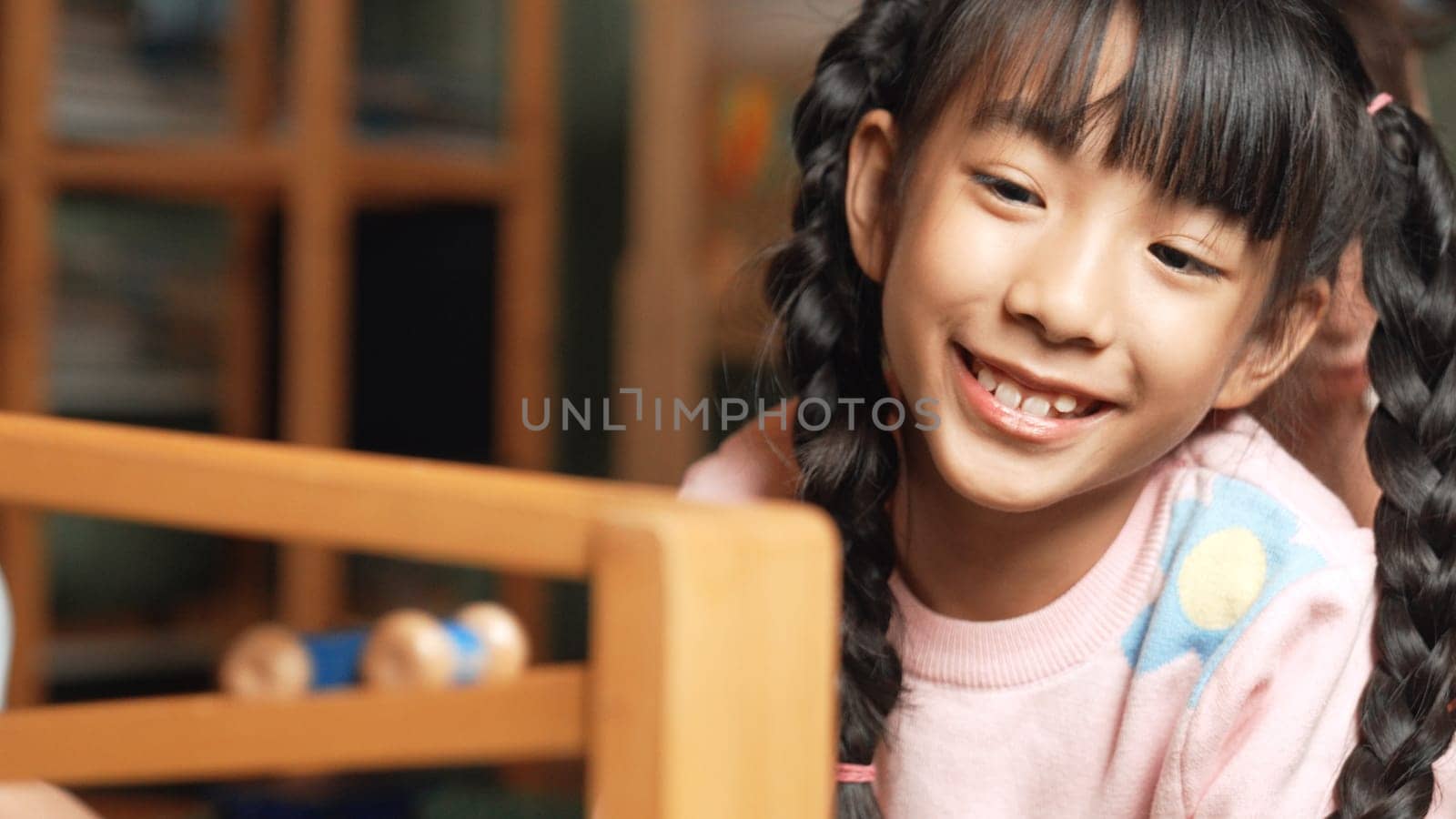 Closeup of cute asian girl playing car toy with friend at play room. Erudition. by biancoblue