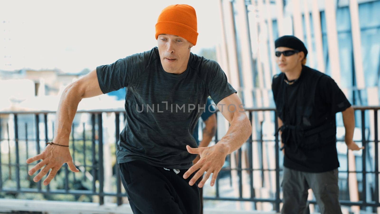 Hipster perform break dancing while partner dancing together at corridor, modern mall. Hip-hop music dancer practice footstep and move to music. Outdoor sport 2024. Active, energetic dance. Endeavor.