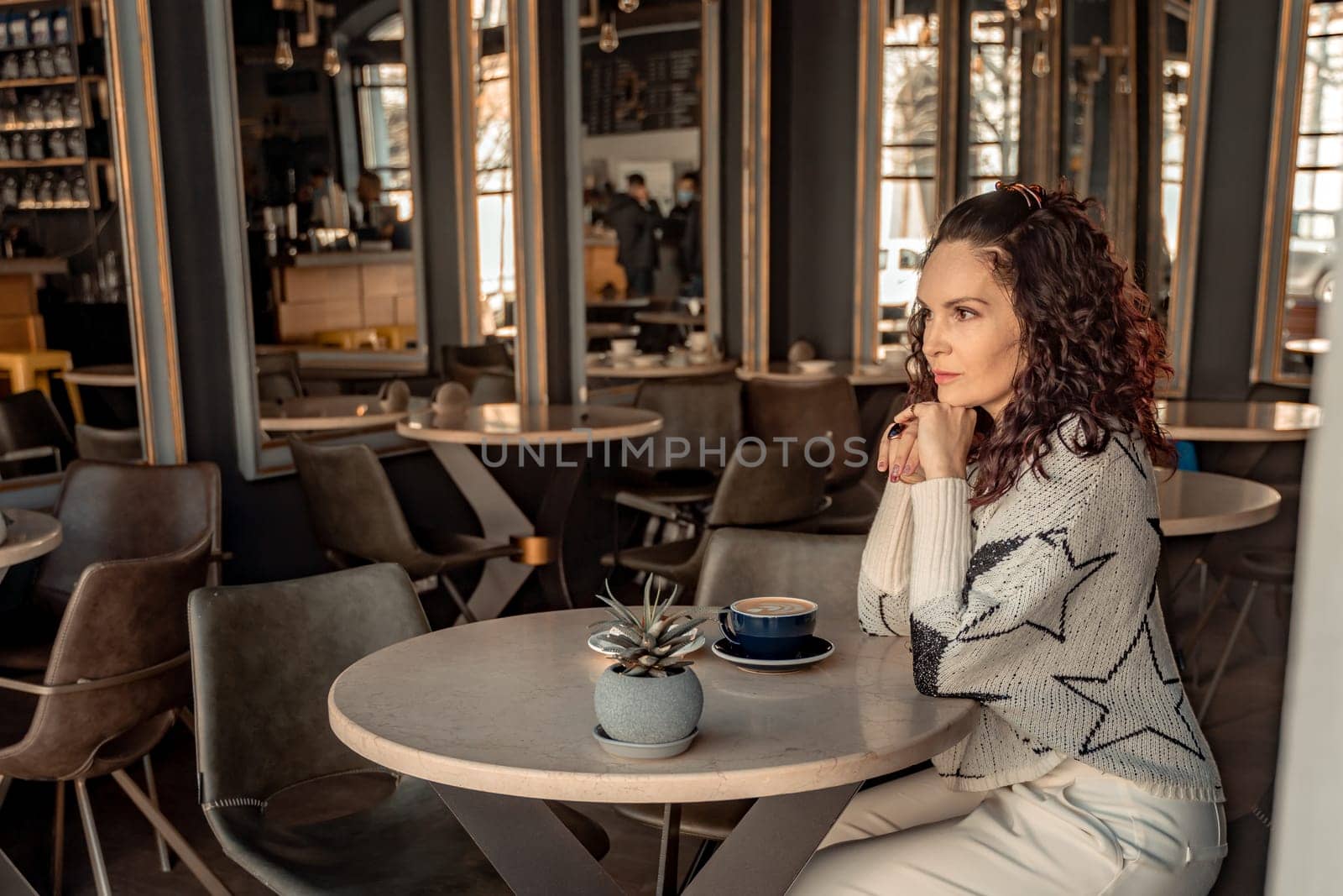 Woman cafe coffee breakfast. Portrait of an adult beautiful woman in an elegant suit in a cafe by Matiunina