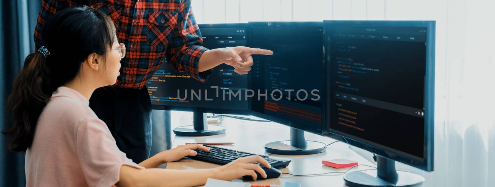 Cropped image of professional programer team collaboration discuss about web coding while coworker point java script displayed on computer at modern company office. Closeup. Burgeoning.