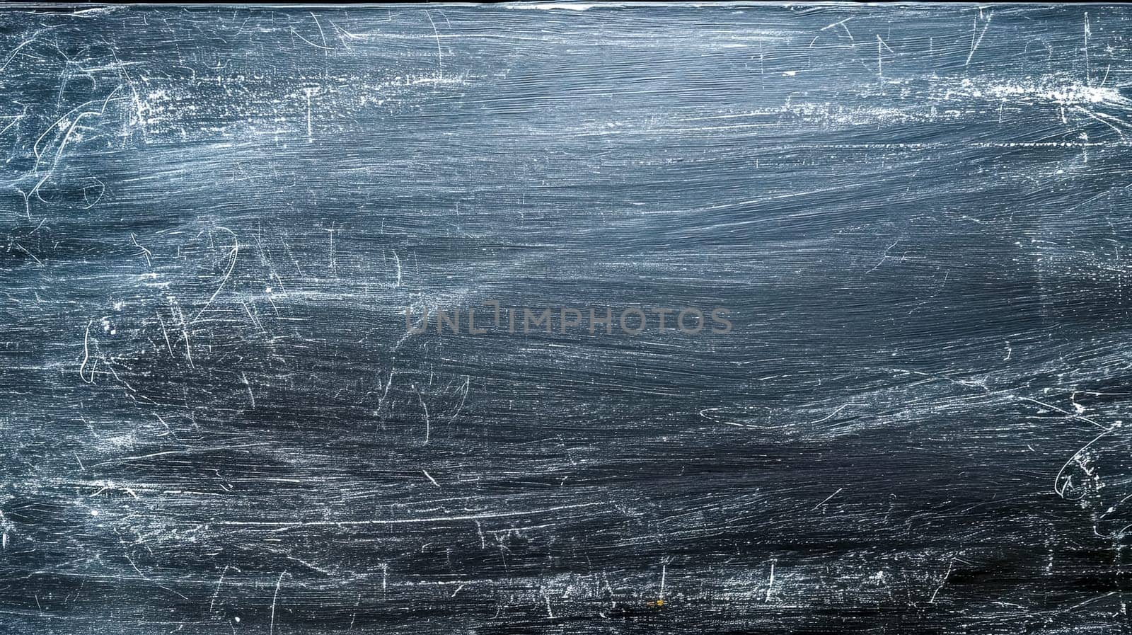 A used black chalkboard fills the image, showcasing the remnants of white chalk marks after erasure, giving it a textured appearance that's both dynamic and familiar. by Edophoto