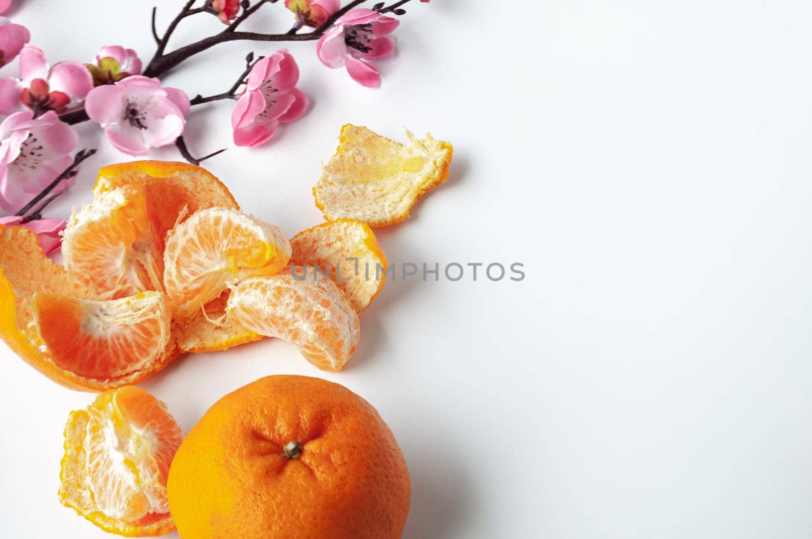 Top view of Mandarin oranges on white background with customizable space for text or wishes. Chinese New Year celebration.