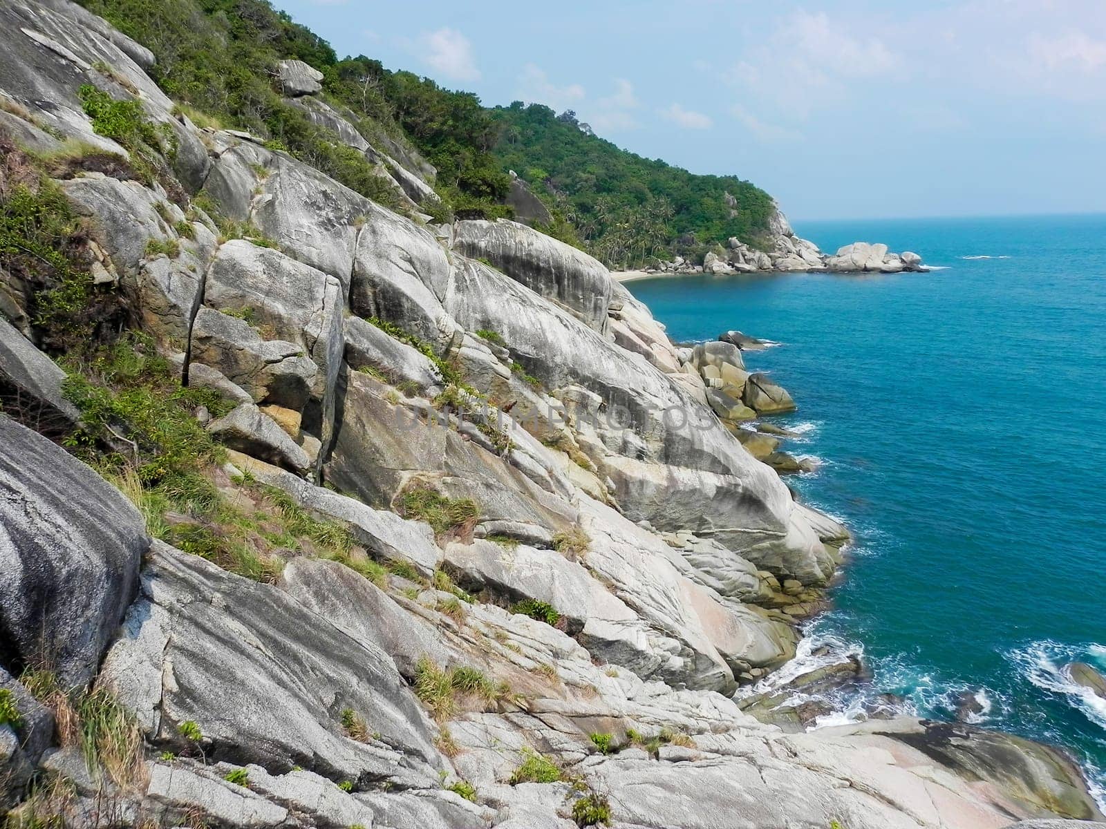 Beautiful coast with azure water cliffs and green jungle on Koh Phangan. Thailand