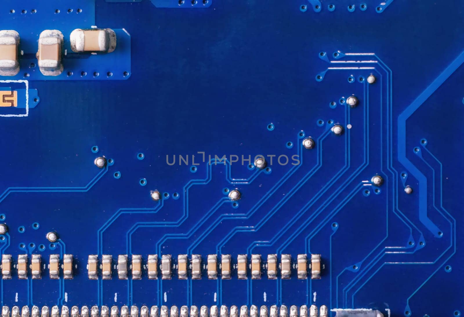 Close up of a printed blue computer circuit board. by Andre1ns