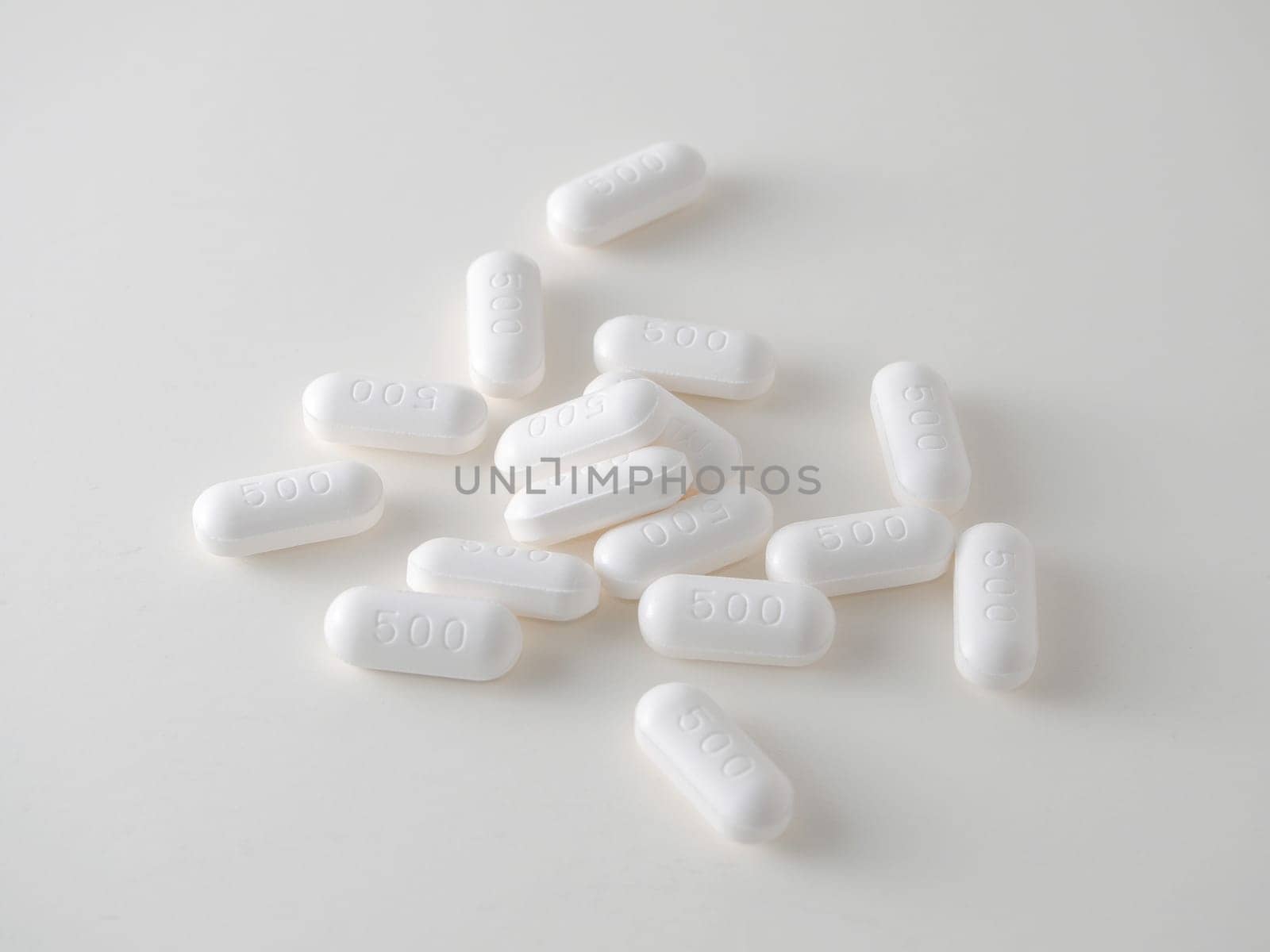 white medical tablets over white.
