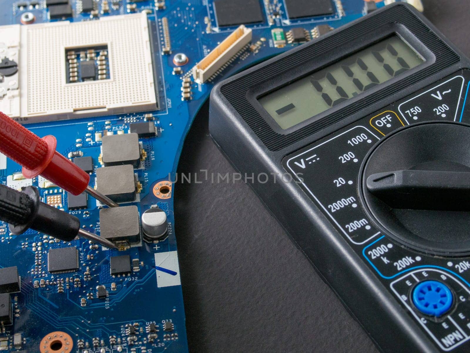 Multimeter test, electronic board of digital device with components. Troubleshoot electronic device. Computer and mobile device repair concept