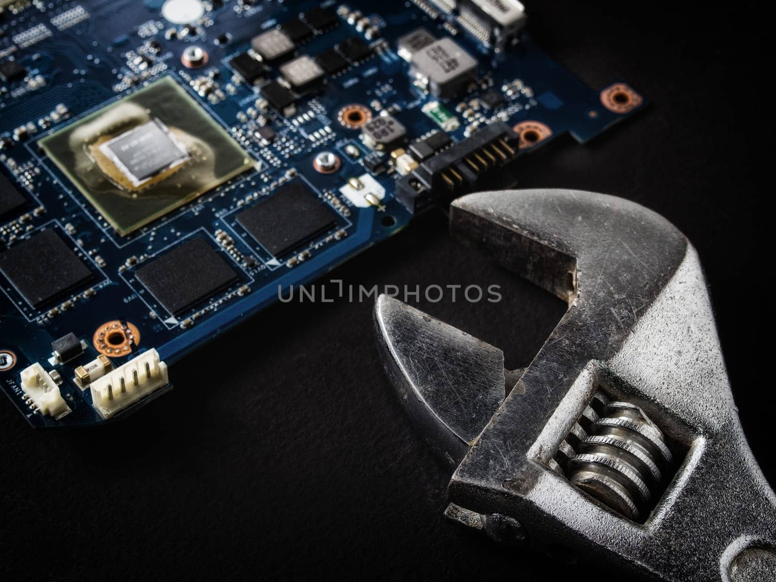 Computer repair concept, wrench on motherboard close up