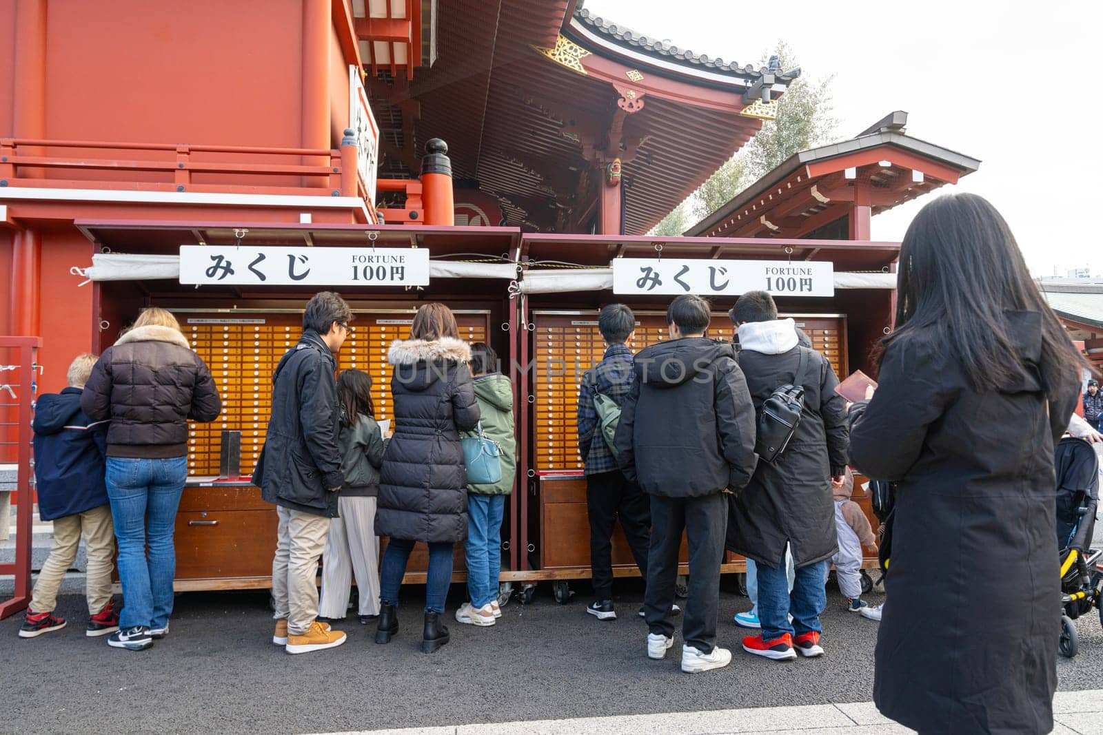 Tokyo, Japan. January 2024. view of the faithful taking the Omikuji, the slips that predict the future at the Senso ji temple in the city center