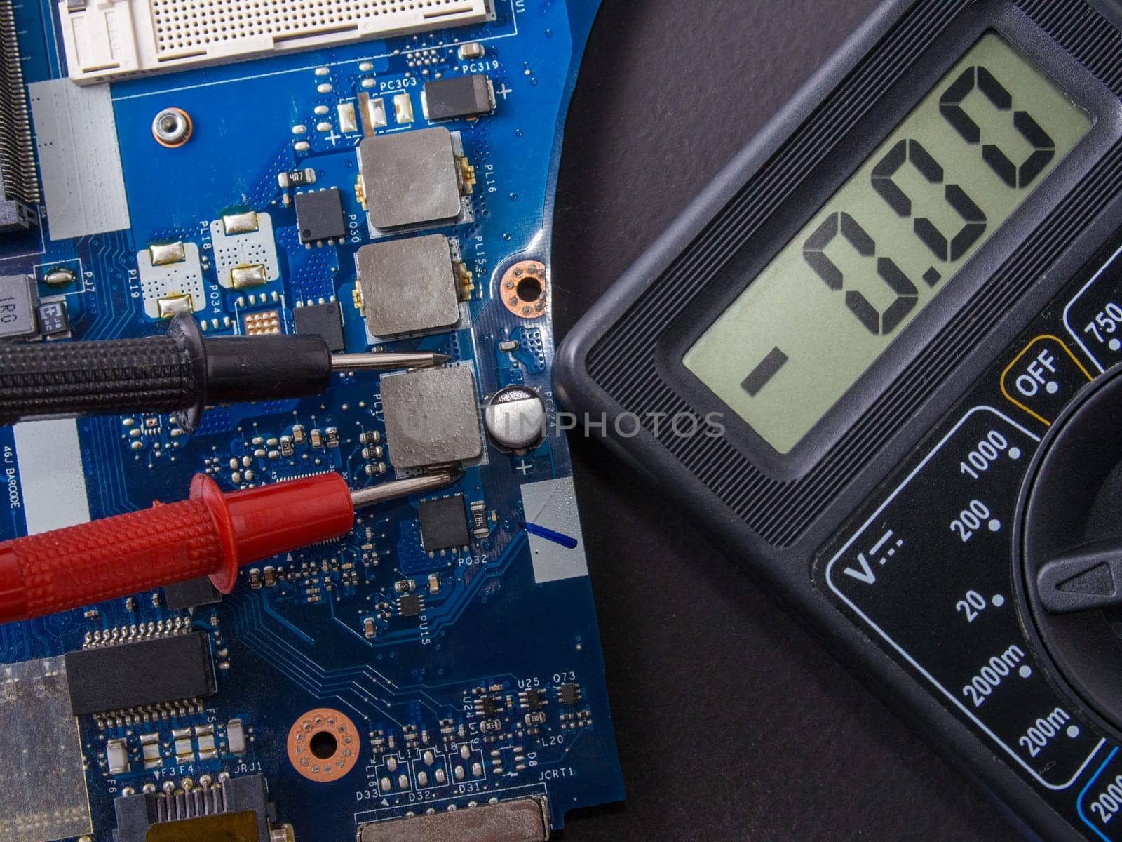 Multimeter test, electronic board of digital device with components. Troubleshoot electronic device. Computer and mobile device repair concept