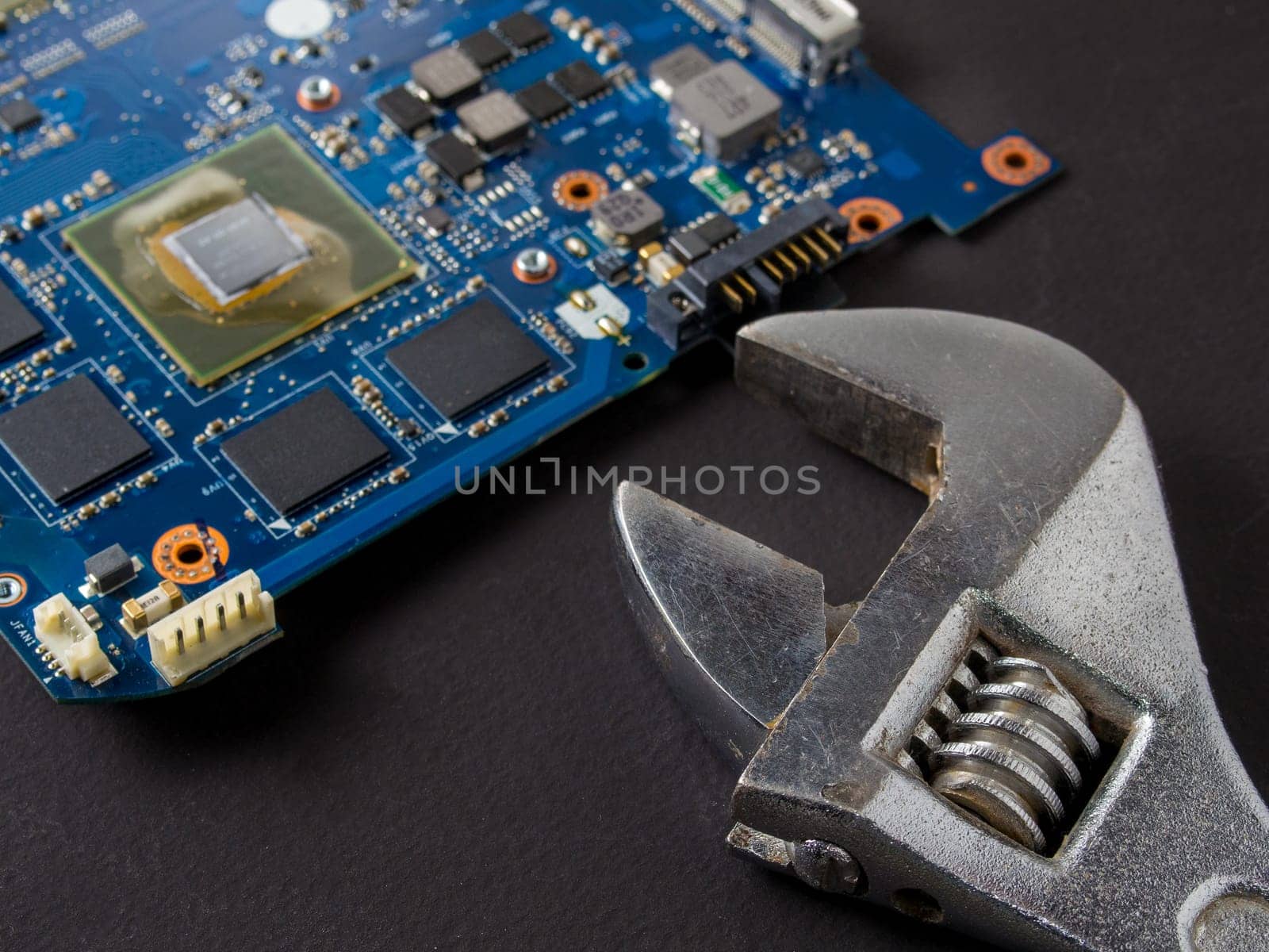 Computer repair concept, wrench on motherboard close up