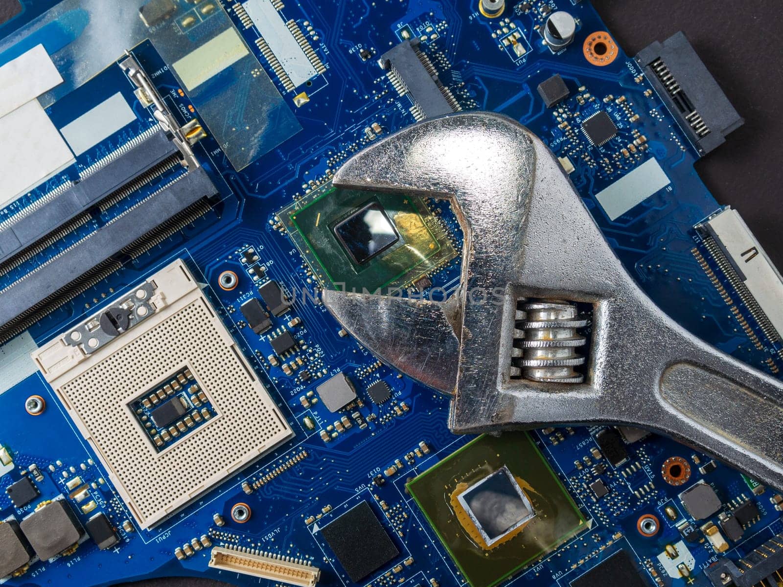 Computer repair concept, wrench on motherboard close up