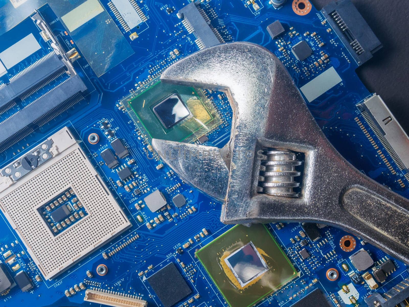 Computer repair concept, wrench on motherboard close up