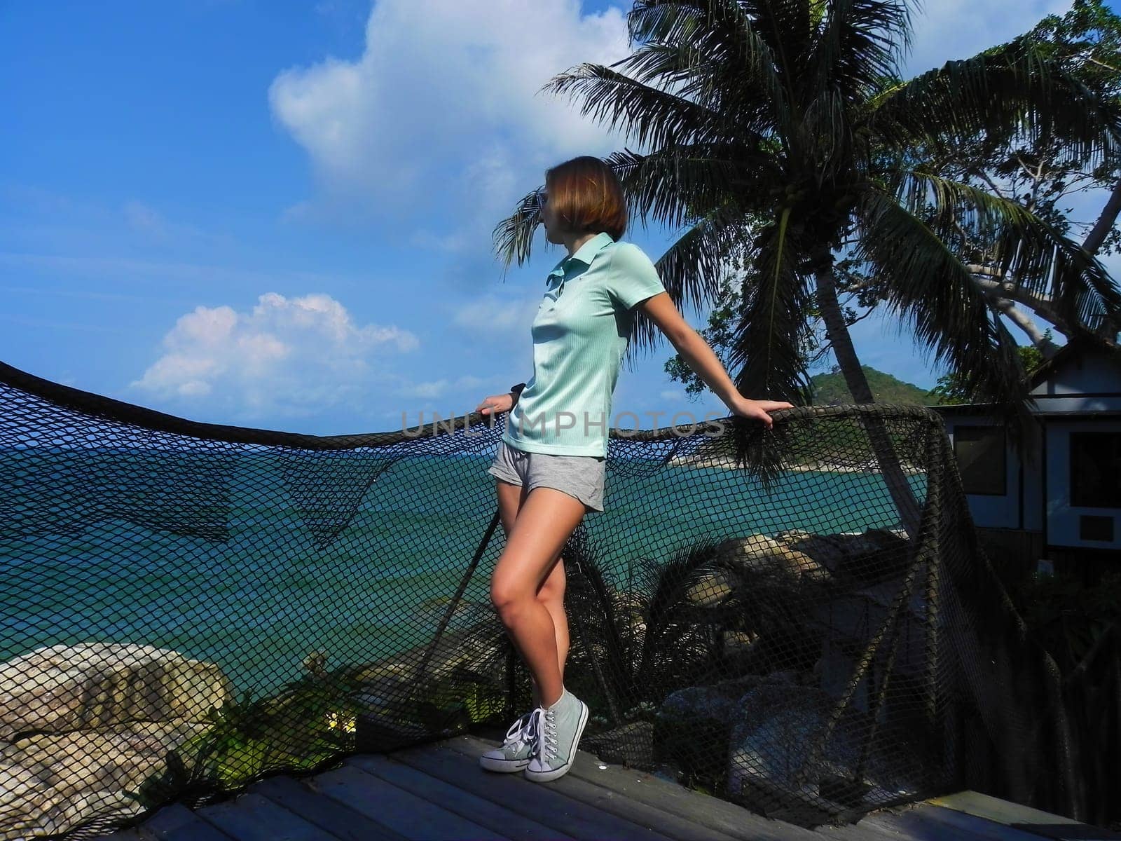 Young girl admiring the beautiful view of the sea.