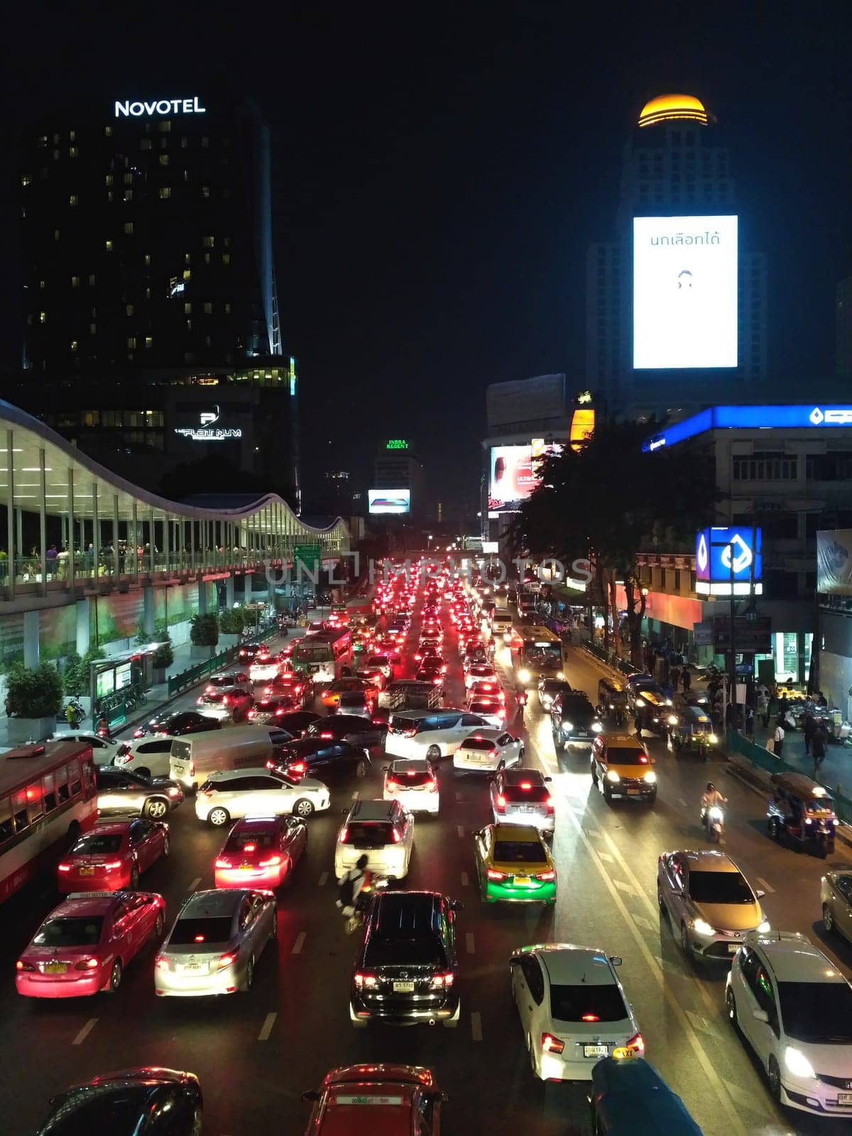 Aerial view of Sathorn road, Bangkok Downtown, Thailand. Financial district and business centers in smart urban city in Asia. Skyscraper and high-rise buildings at night. Urban city background.
