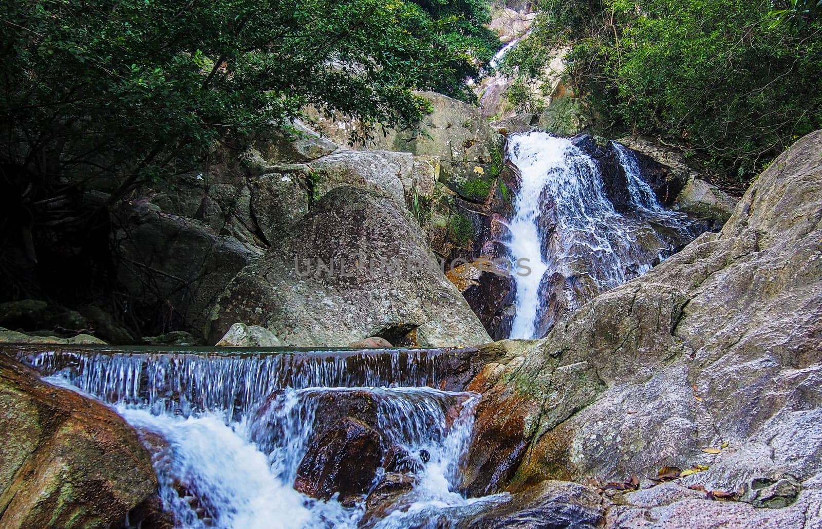 Motion Blur Waterfalls Peaceful Nature Landscape in Blue Ridge Mountains with lush green trees, rocks and flowing water