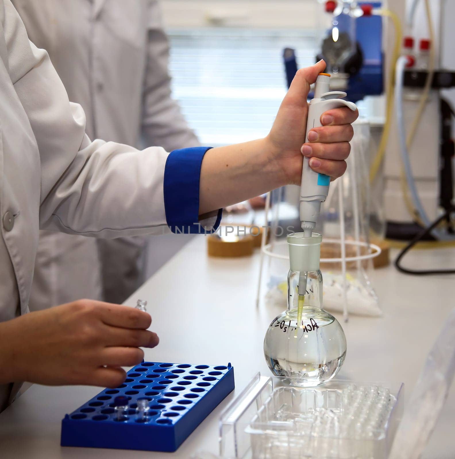 The doctor takes a test tube with liquid, close-up. Work in a chemical laboratory. Laboratory analysis