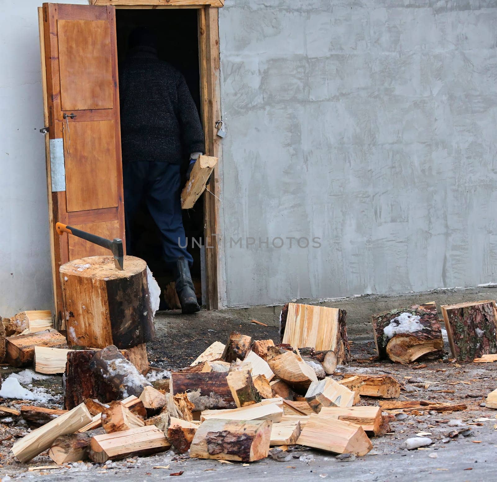 Old ax and a deck for chopping wood. Dry firewood, chopped wood for winter heating of the fireplace.