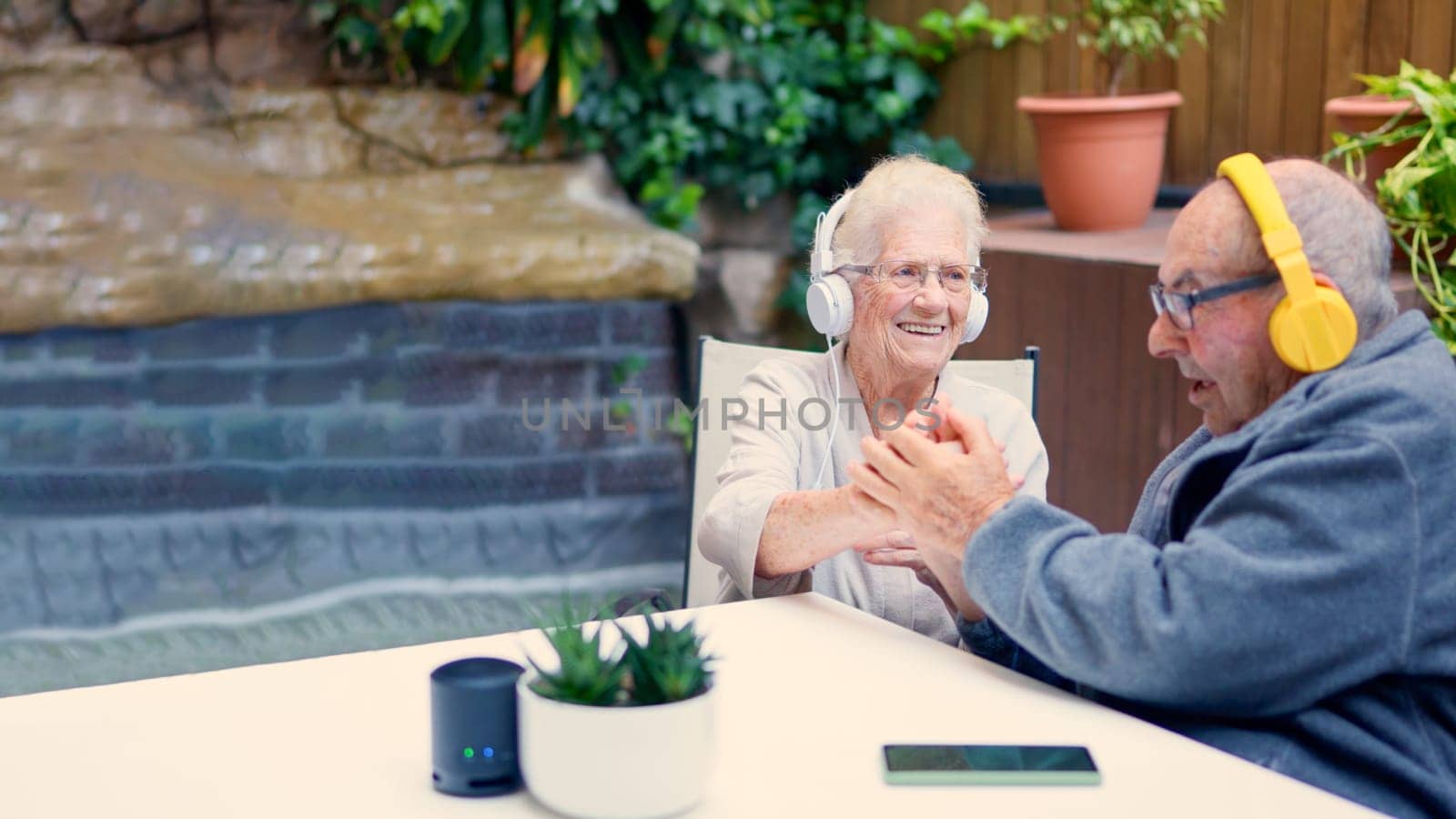 Photo of senior couple listening to music and congratulating each other