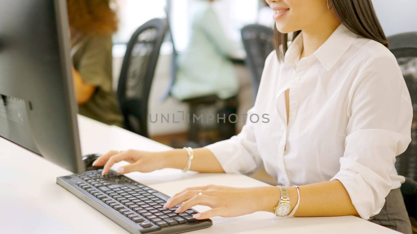 Close-up photo of the hands of an asian woman using computer in a coworking