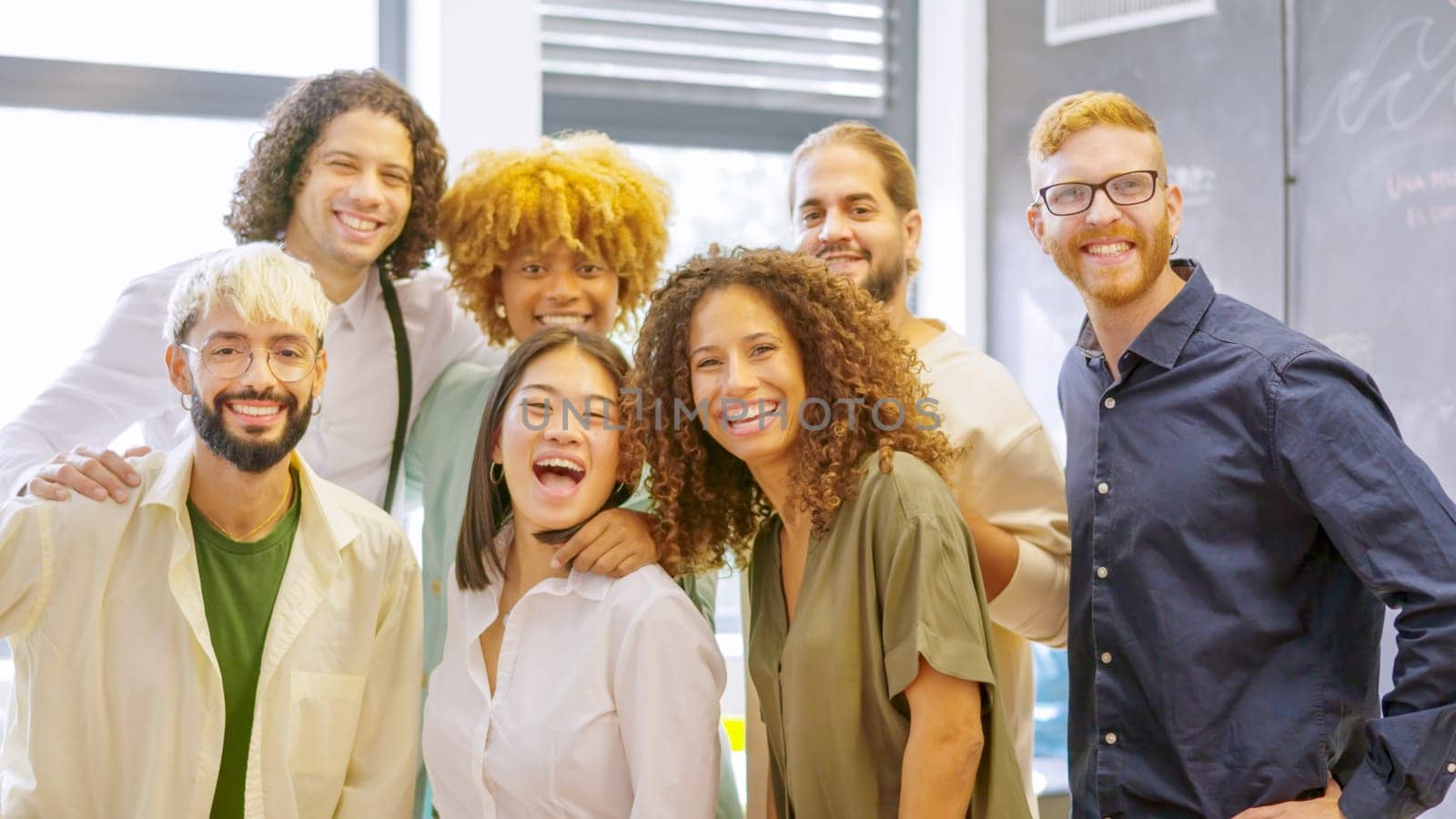Photo of a group of multi-ethnic coworkers smiling at camera together