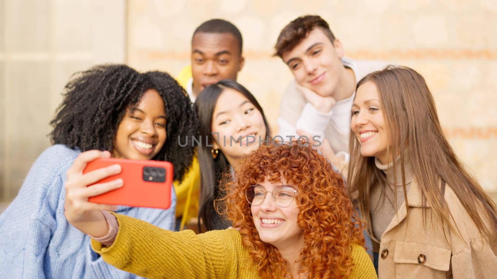 Group of diverse friends taking a selfie and smiling in the city