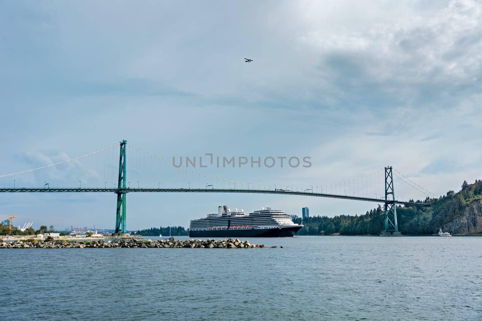 View of Vancouver harbor with huge ocean cruise liner passing famous Lion Gates Bridge in Vancouver downtown, Canada