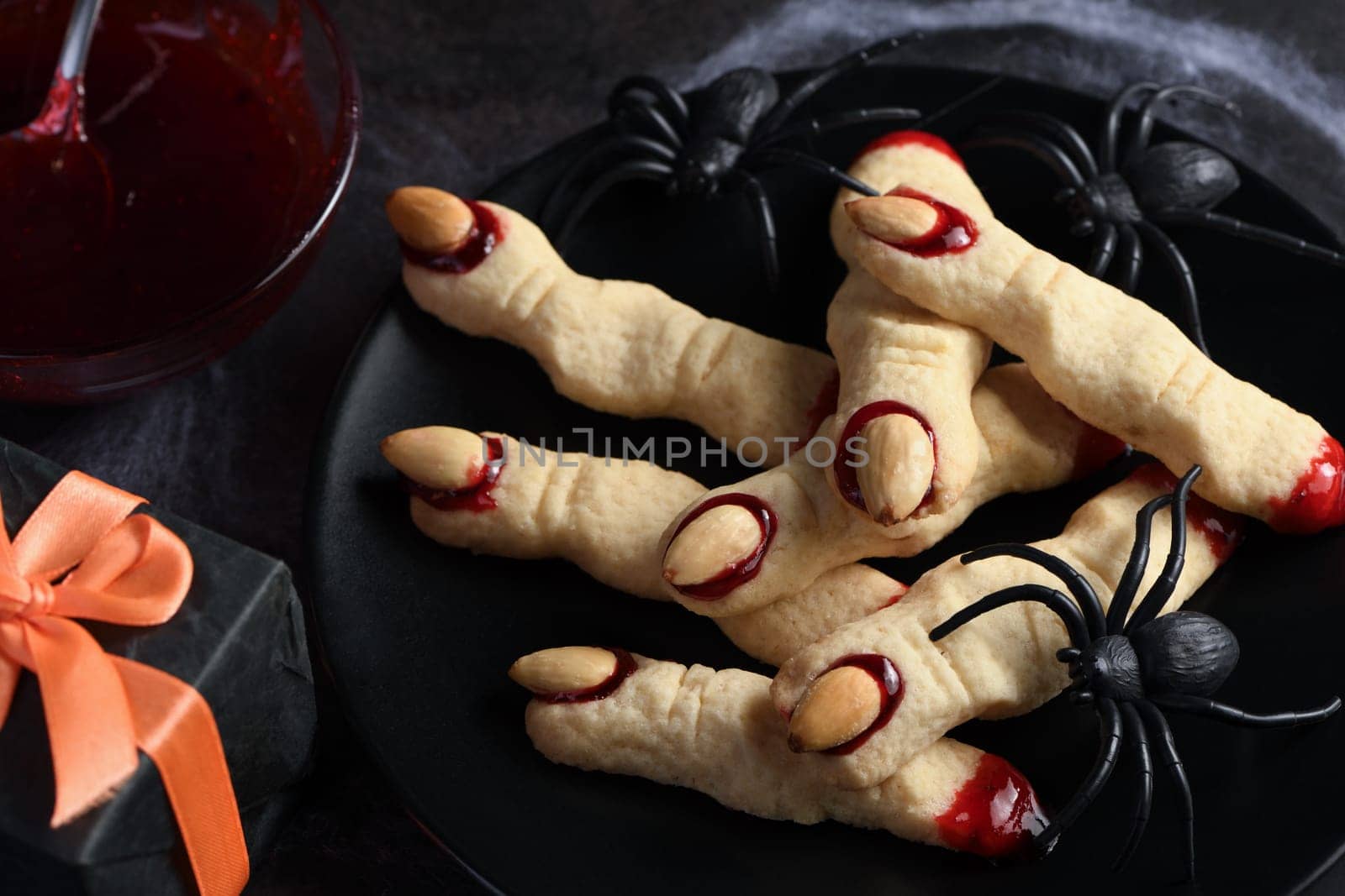 Creepy, scary Witch fingers made from sugar cookies with raspberry jam and almonds on Halloween. Trick-or-treat. Classic Cookie Witch Fingers takes on a healthy, gluten-free, paleo, vegan look.