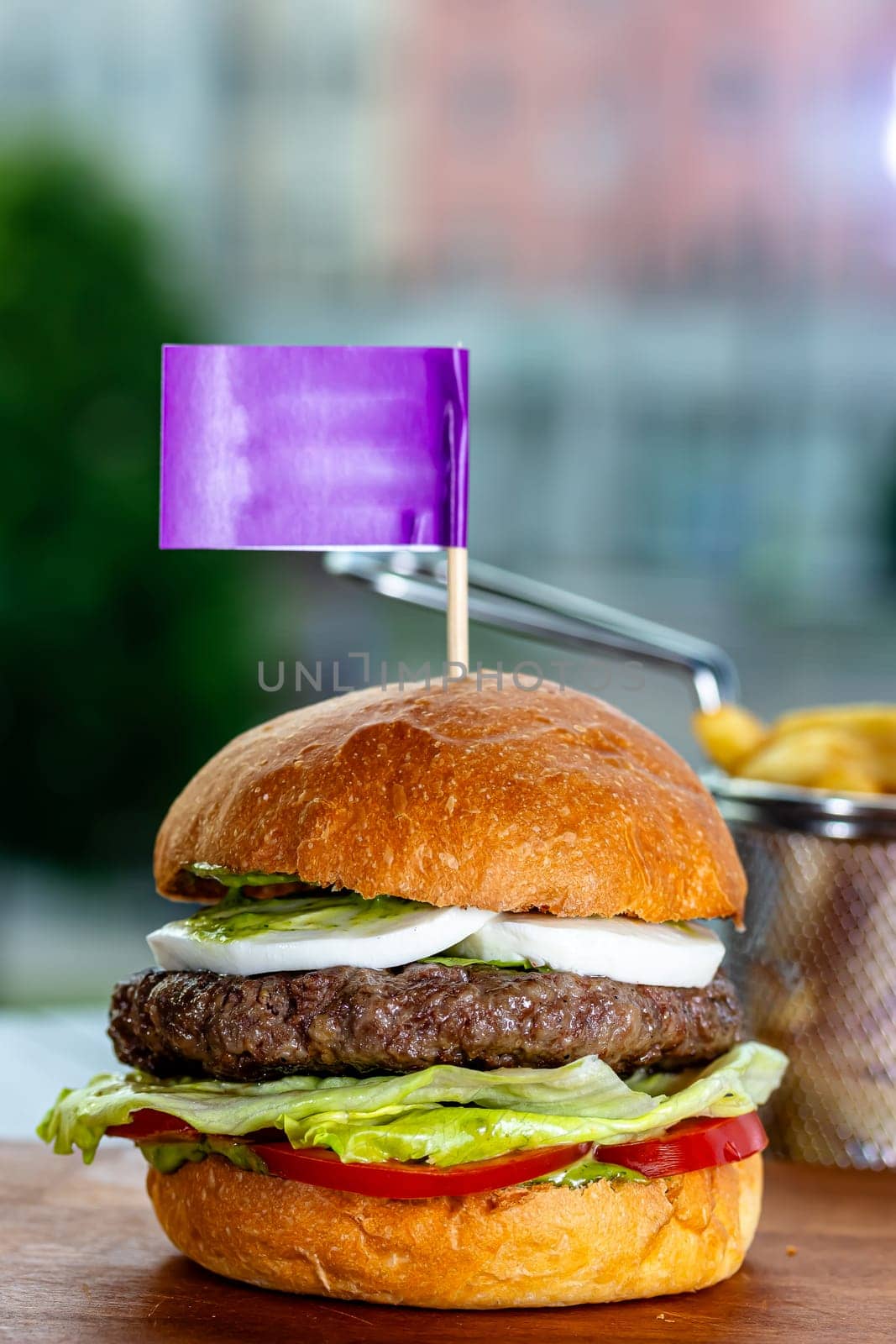 Lamb burger. Hamburger made with lamb meat. Classic traditional Greek variation of the classic American burger tradition. seasoned lamb meat with feta cheese, red onion, cucumbers and Greek mayo by Milanchikov