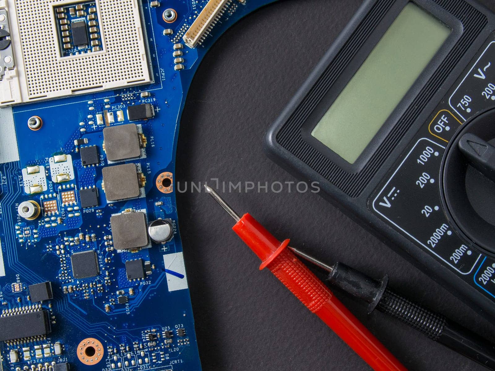 Multimeter test, electronic board of digital device with components. Troubleshoot electronic device. Computer and mobile device repair concept