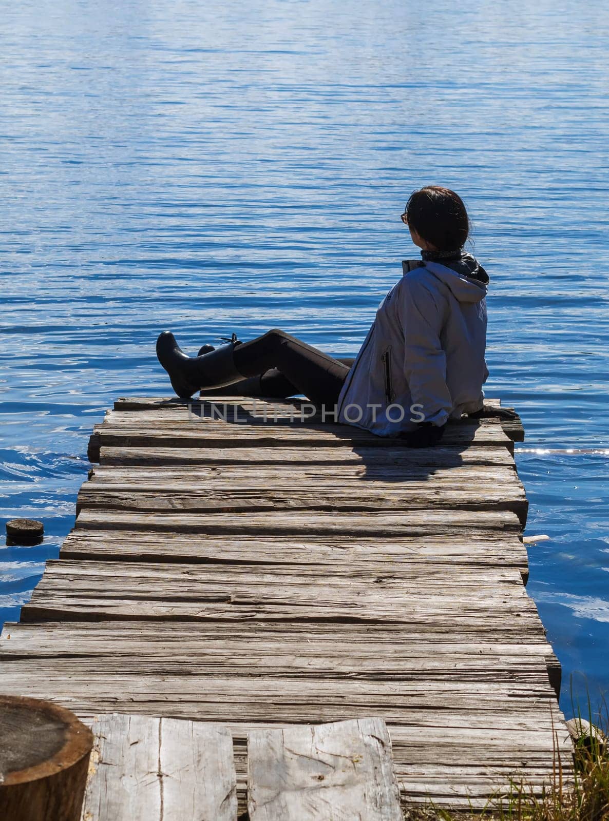 girl on a wooden pier by the lake
