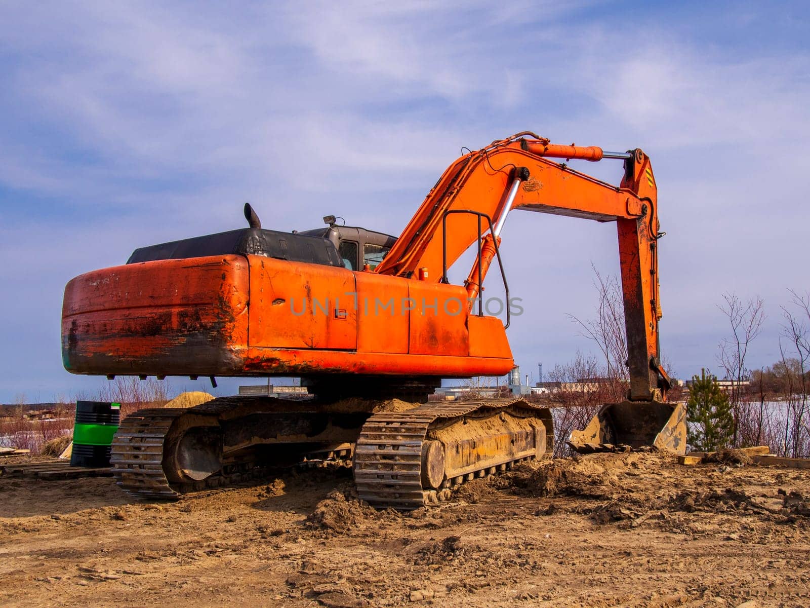 Powerful orange excavator in rural area by Andre1ns
