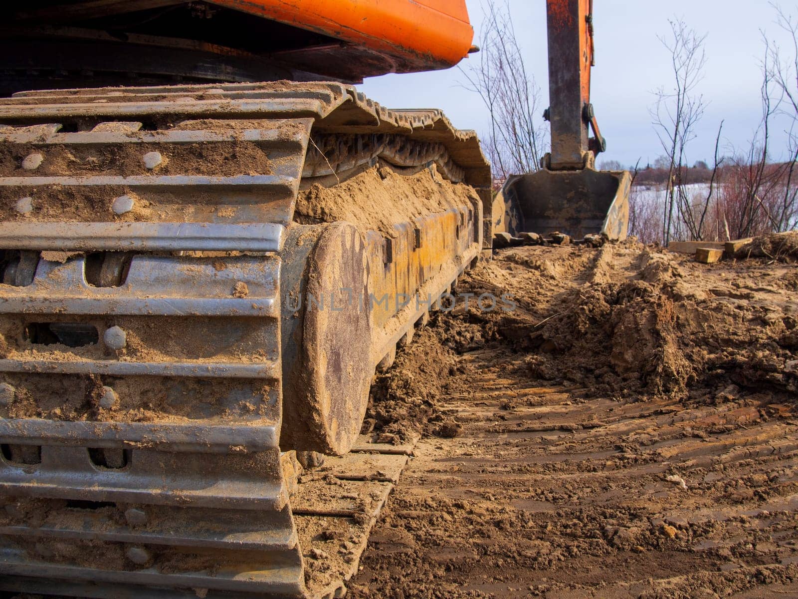 Powerful orange excavator in rural area