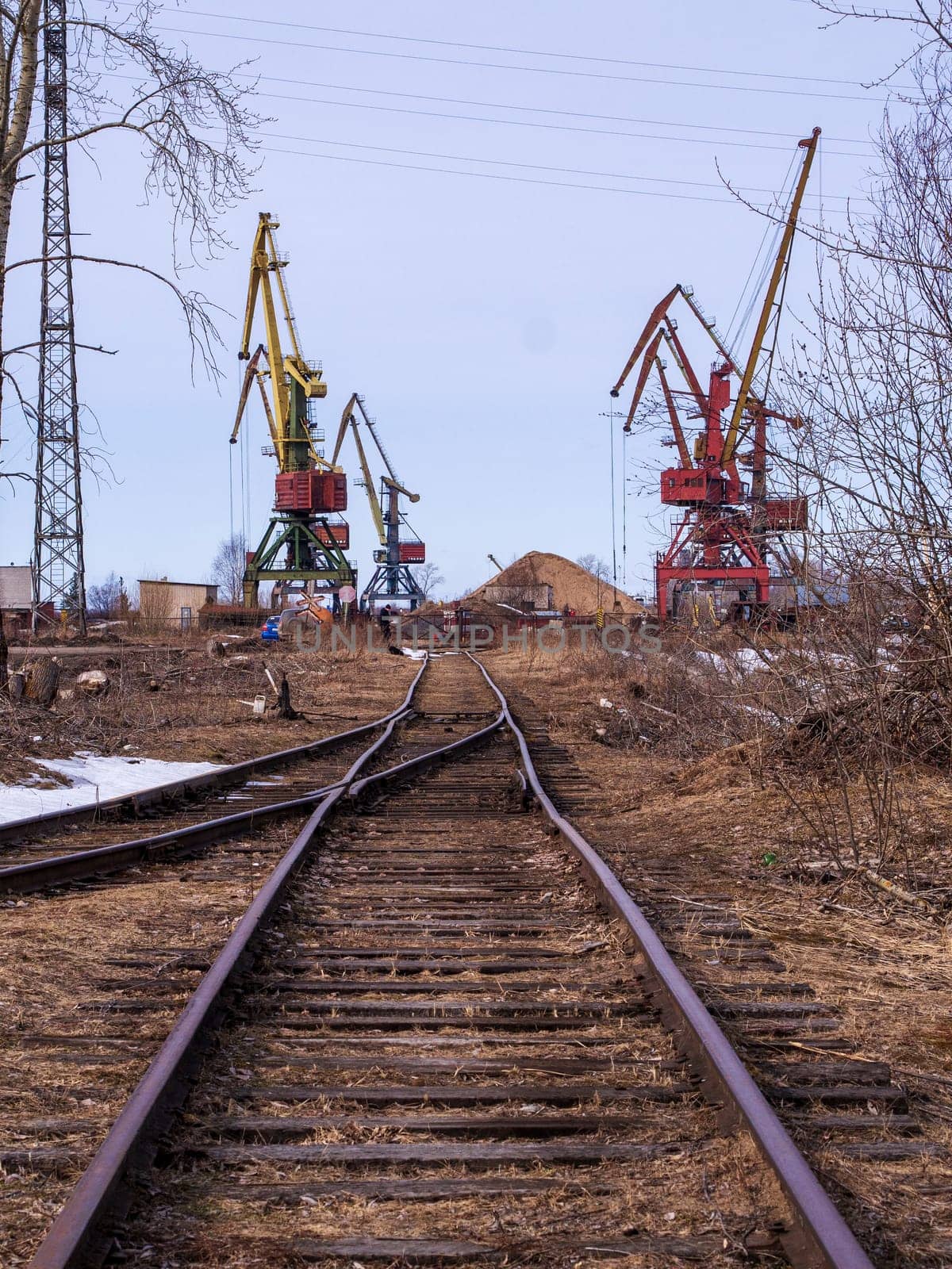 Rail road tracks under the gantry cranes on the berth of sea merchant port
