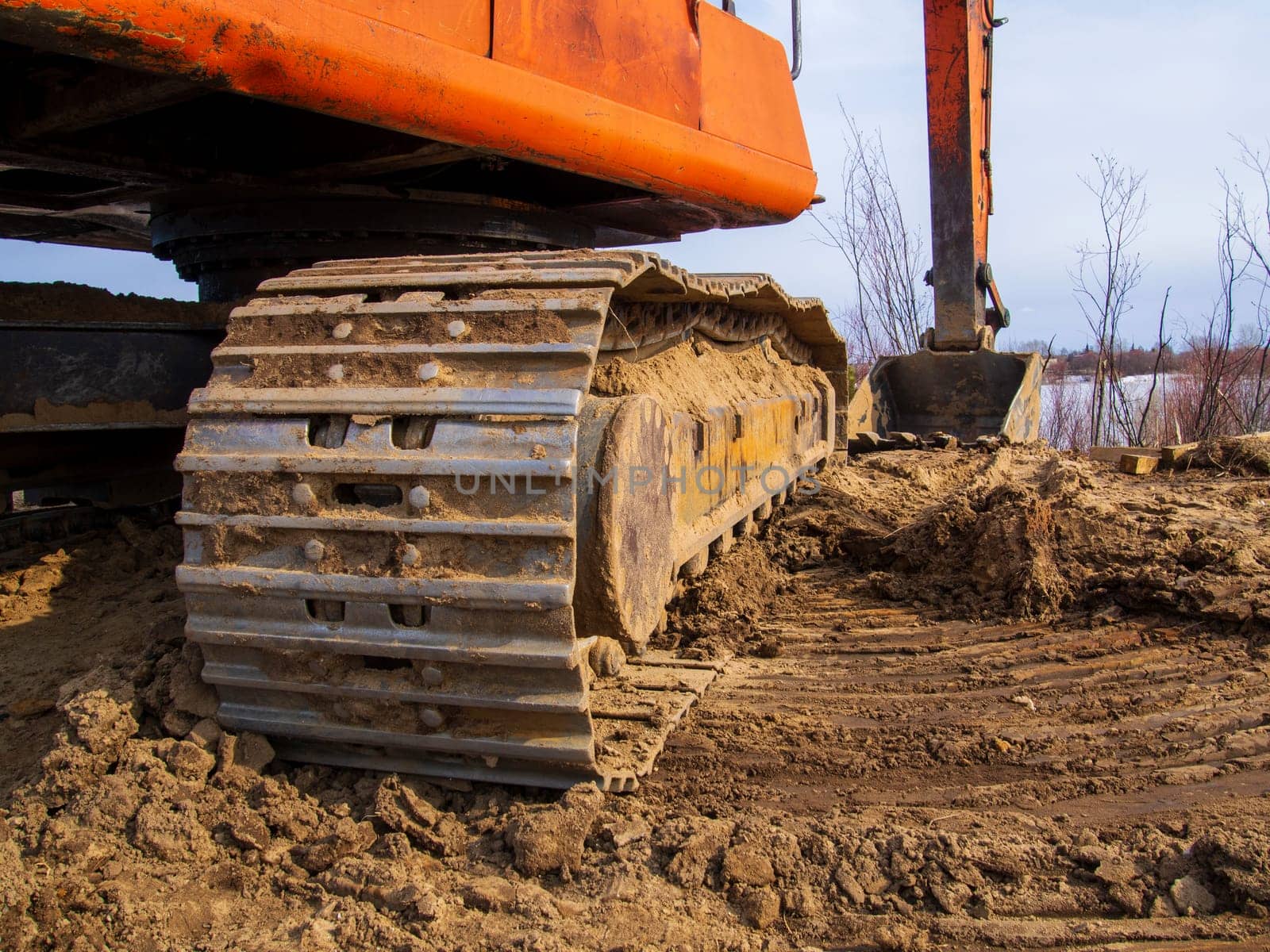 Powerful orange excavator in rural area