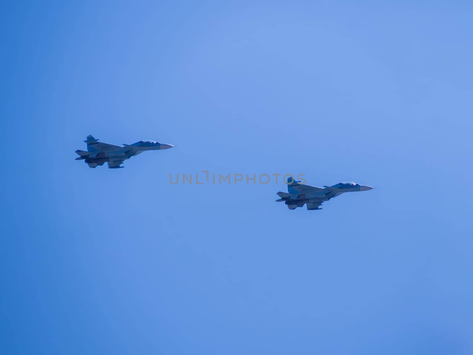 Russia, St. Petersburg - June 24, 2020: Demonstration flight of two Russian-made su-30SM multirole fighters. Russian military su-30SM plane of the Russian Air Force in flight at the Victory Parade in World War II. by Andre1ns