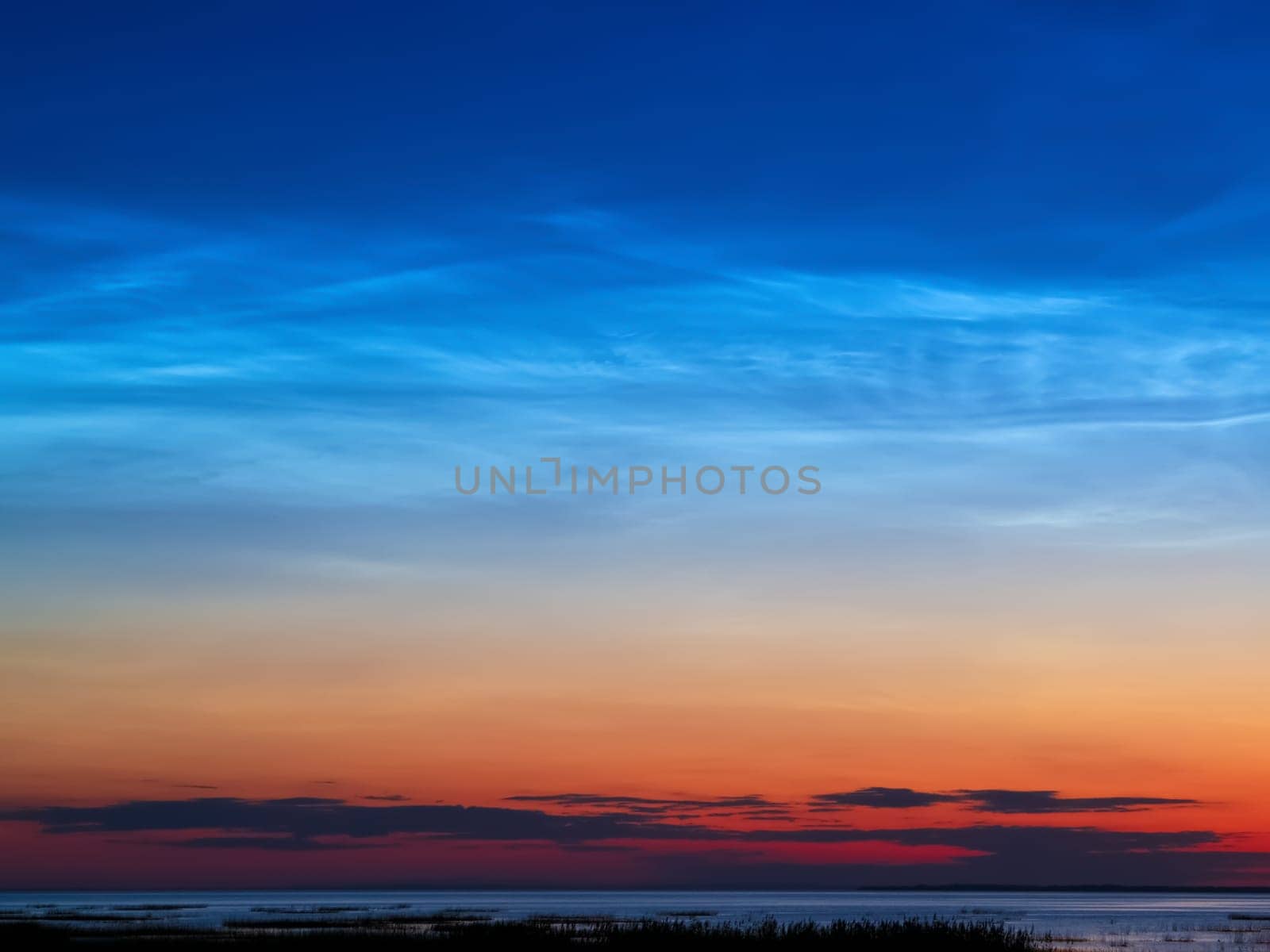 Sunset river horizon sky clouds. River sunset landscape. Sunset river view. Sunset river panorama