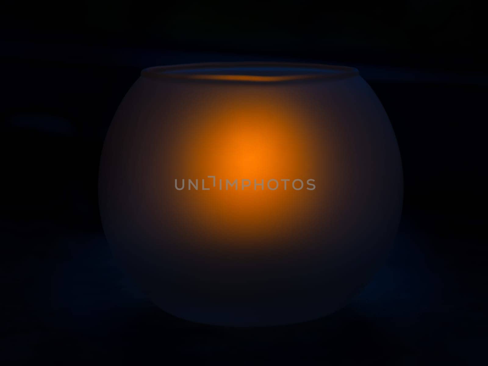Frosted glass candlestick with a burning candle