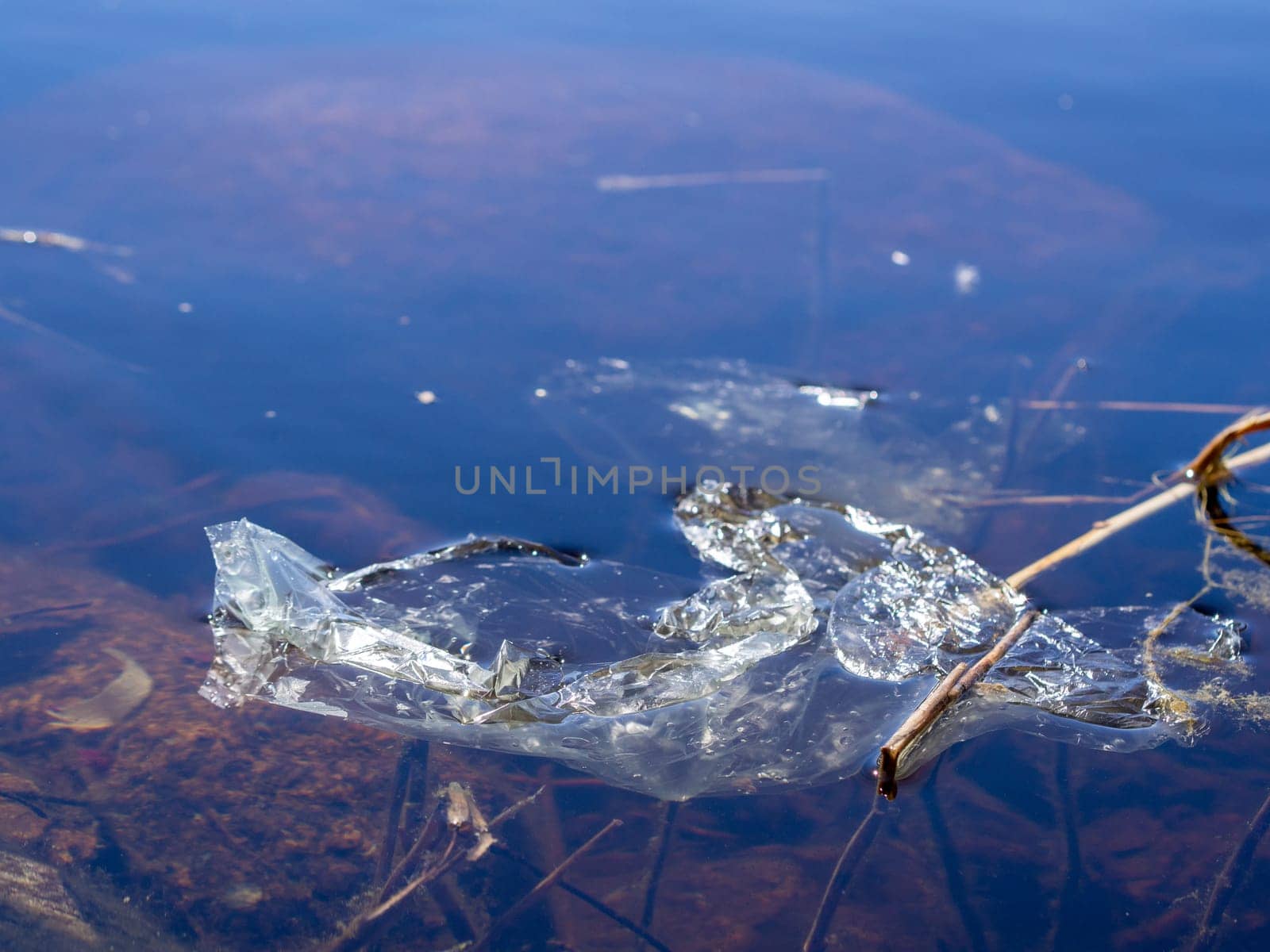 Underwater pollution: - discarded plastic bag in the river