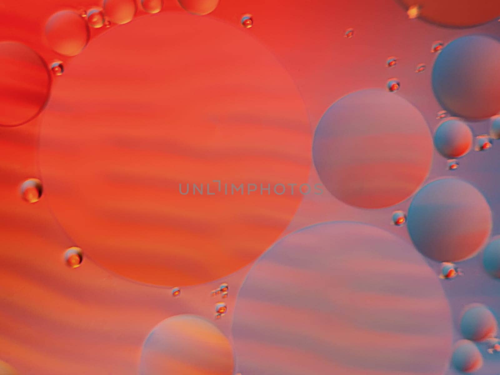 Abstract oil spots in motion on water on blurred yellow background. Photo with small depth of field.
