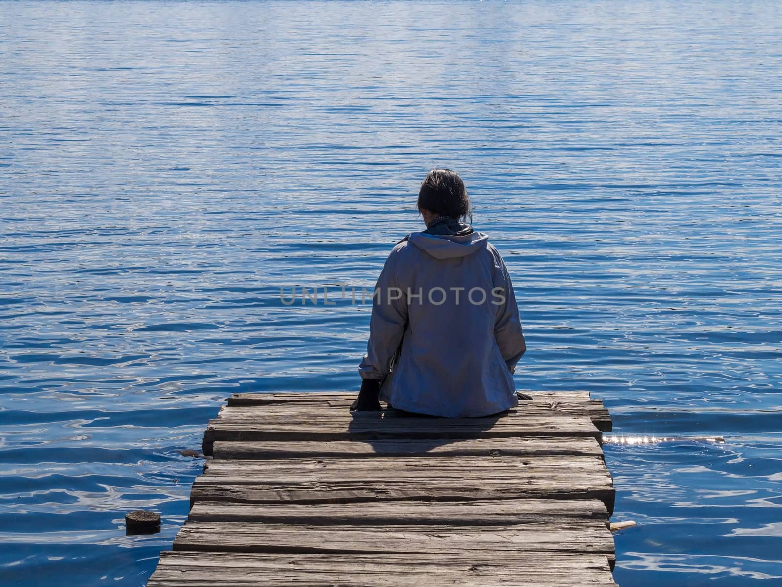 girl on a wooden pier by the lake
