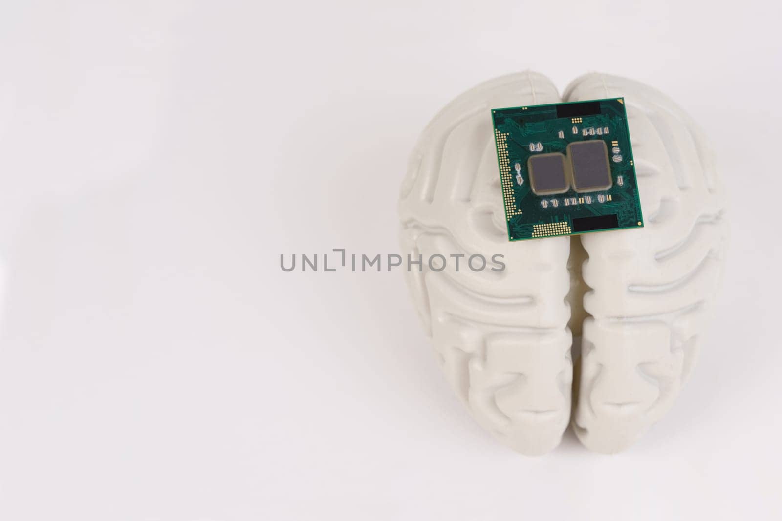 Human brain and computer chip. Microprocessor in the head, on a white background.