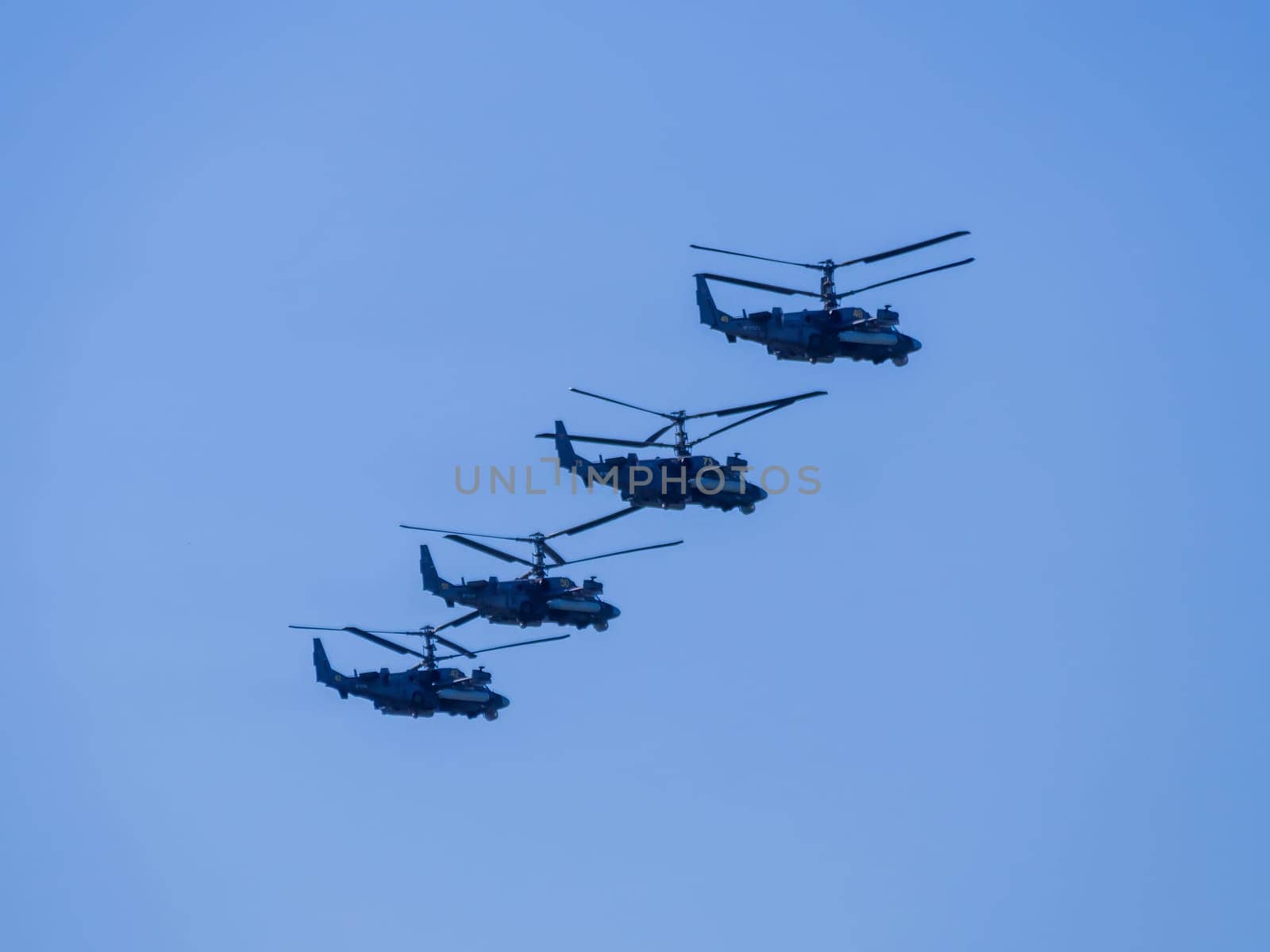 Russia, St. Petersburg - June 24, 2020: Russian military helicopters alligator Ка-52 of the Russian Air Force in flight at the Victory Parade in World War II.