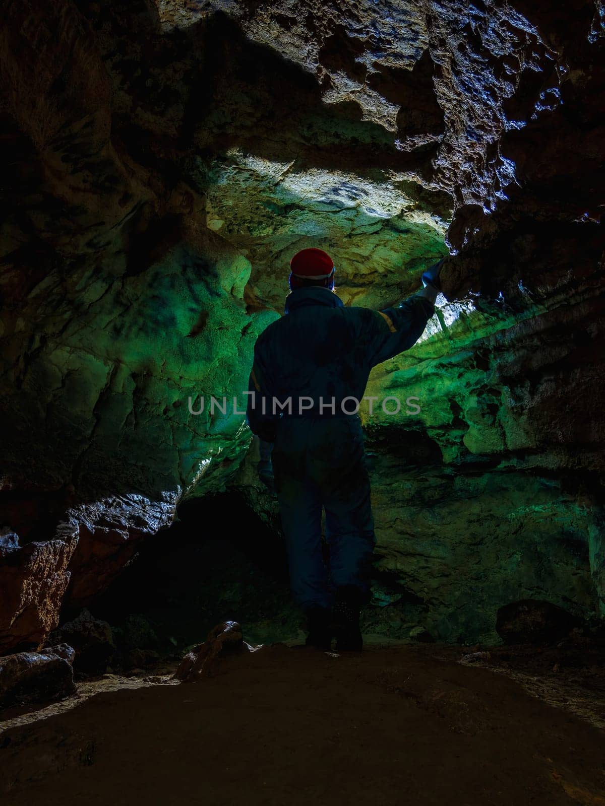 Young girl caver exploring in the cave