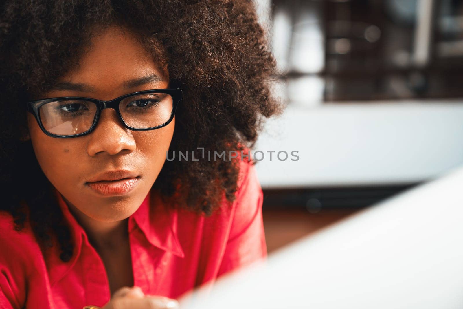 Portrait of young African woman creating website developer, thinking data information designer at home office, focusing on laptop. Concept of analytical data center in java project job. Tastemaker.