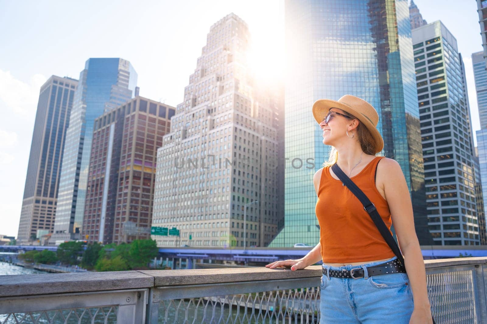 Young woman with hat happy traveling in New York. City skyline. High quality photo