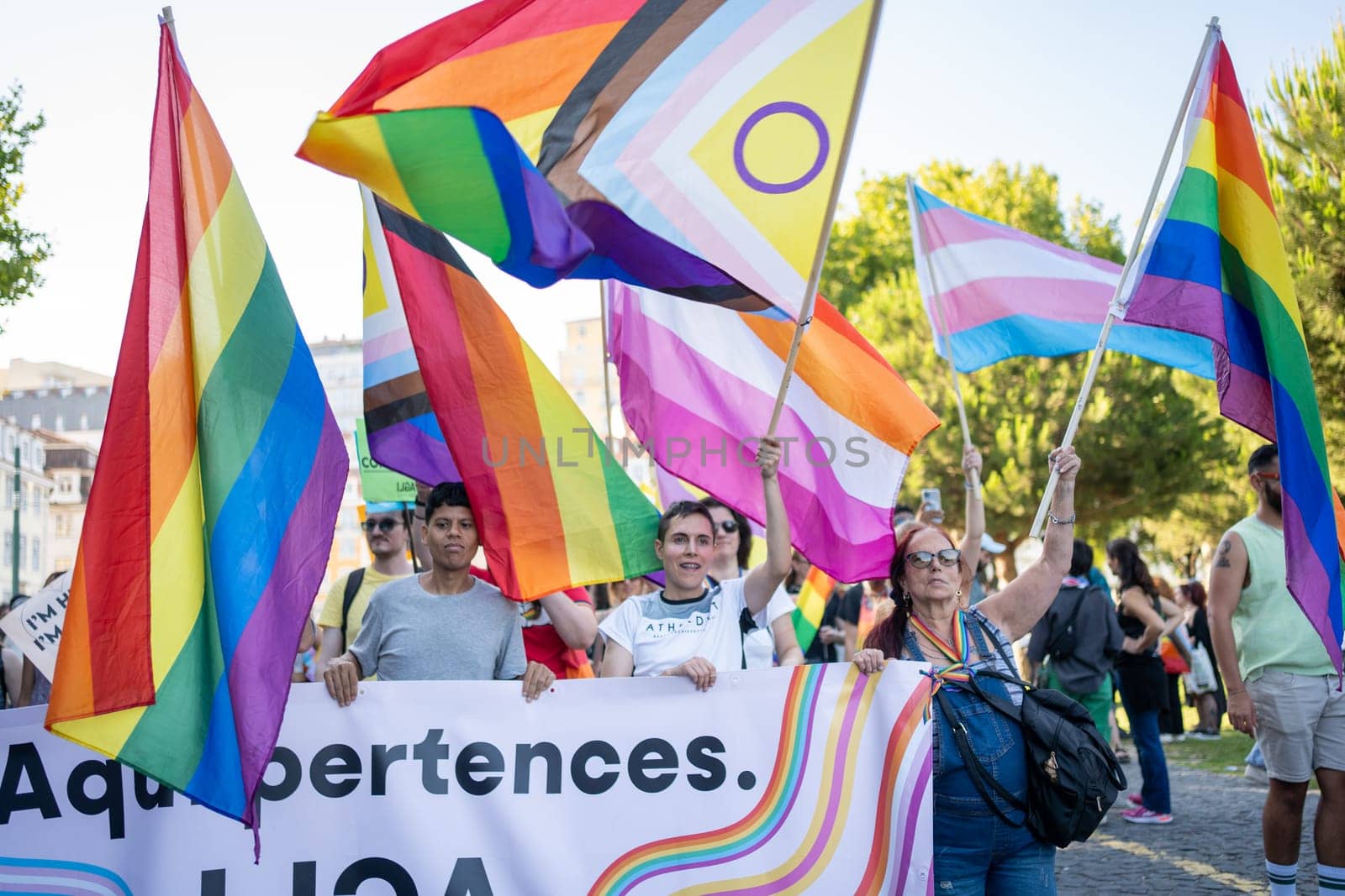 Lisbon, Portugal. 17 June 2023: LGBTQ parade in support of people of non-traditional orientation. Cheerful people carrying rainbow flags and banners. LGBTQ activists at Pride Parade