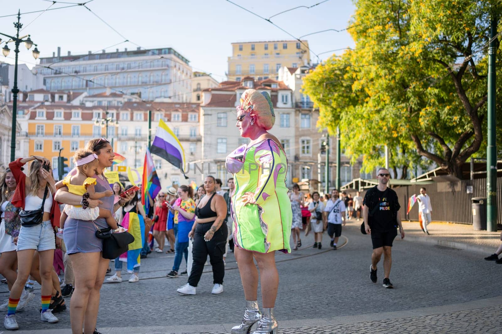 Lisbon, Portugal. 17 June 2023 Drag queen at Pride Parade in brightly colored costume. European drag queen in wig and makeup walking promenade. Respect, sexual equality, pride LGBT people