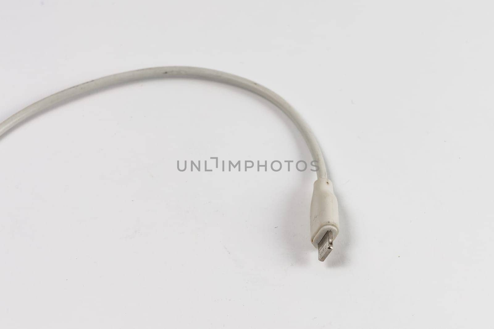 Long white cable with Lightning connector at the end for iPhone chargers by Wierzchu