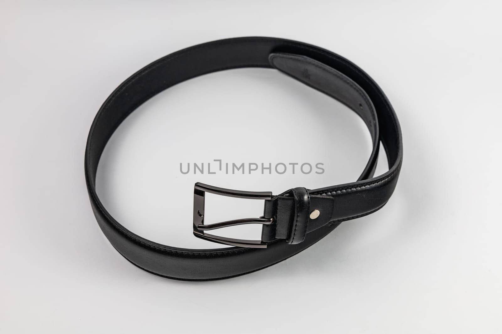 Long and wide black leather belt with few small holes and metallic big buckle